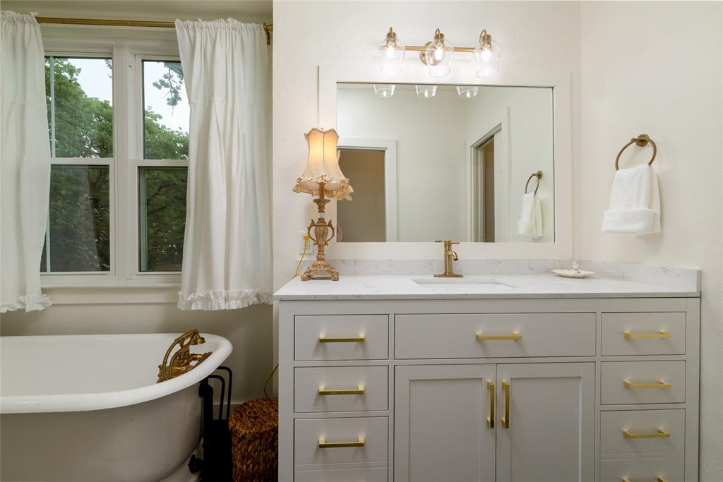 8948 David Fort Road Argyle, TX 76226 - Photo 23 of 39 White clawfoot tub with brass fixtures