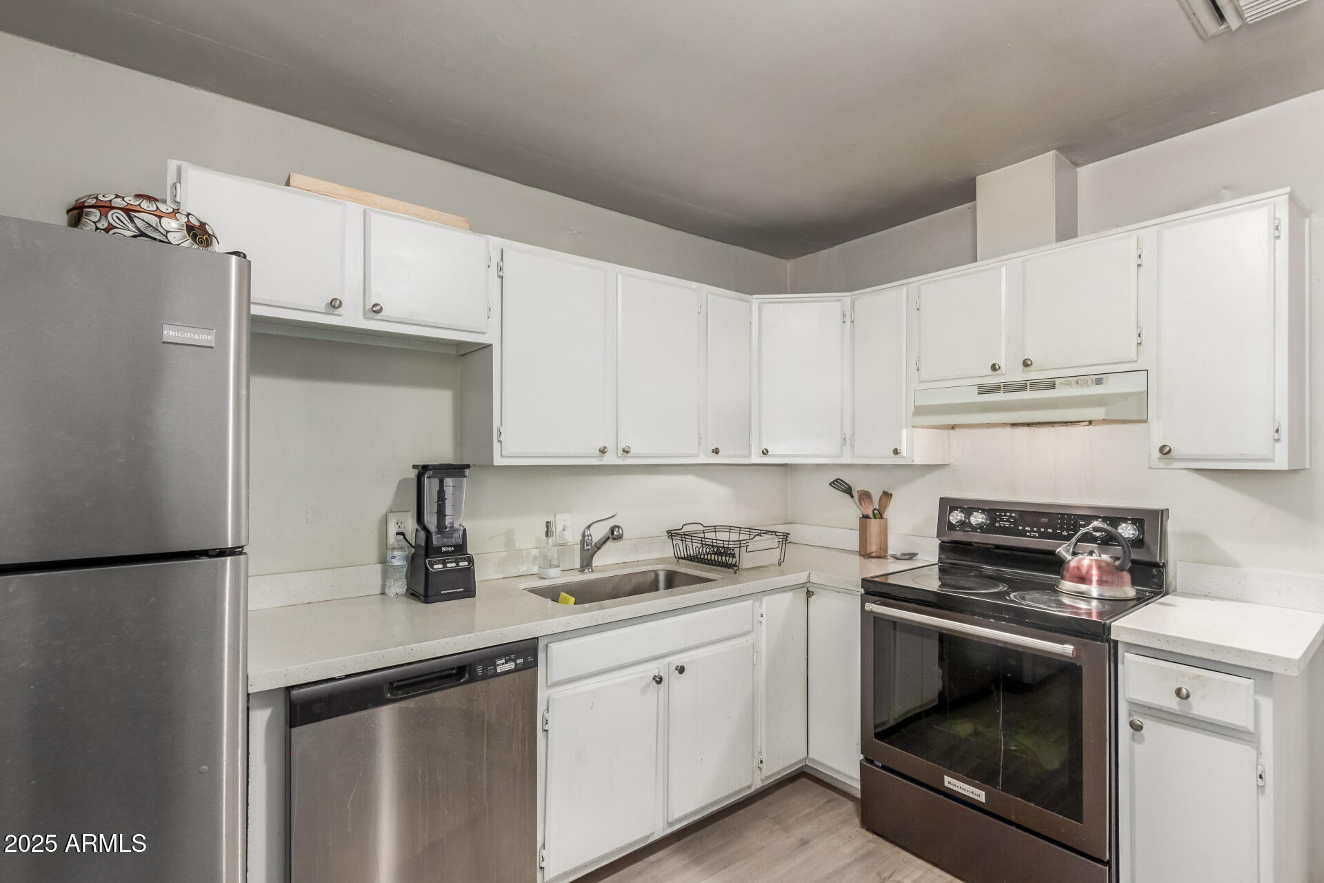 2752 West Royal Palm Road Phoenix, AZ 85051 - Photo 12 of 23 a kitchen with cabinets appliances and a sink