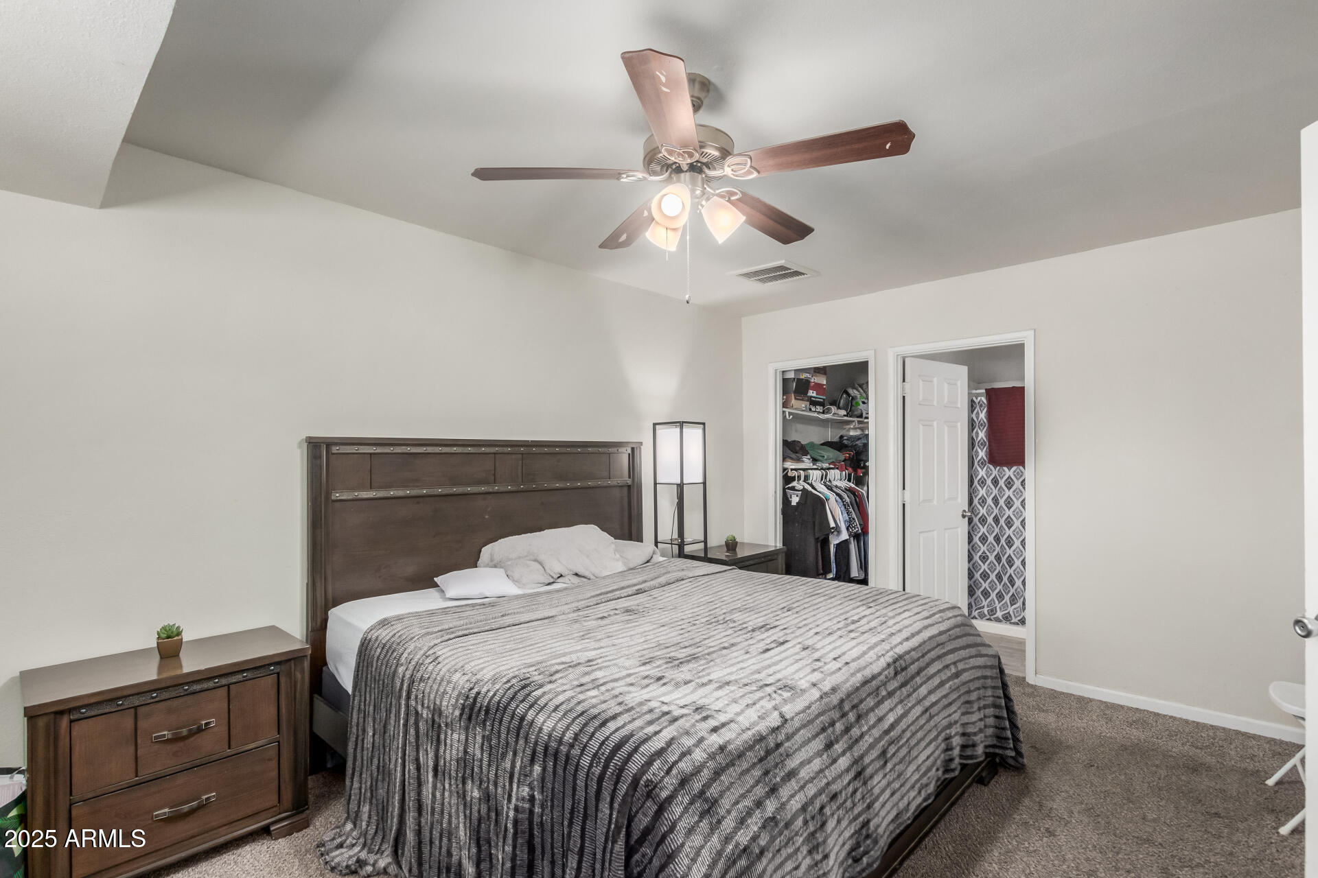 2752 West Royal Palm Road Phoenix, AZ 85051 - Photo 13 of 23 a bedroom with a bed and a chandelier