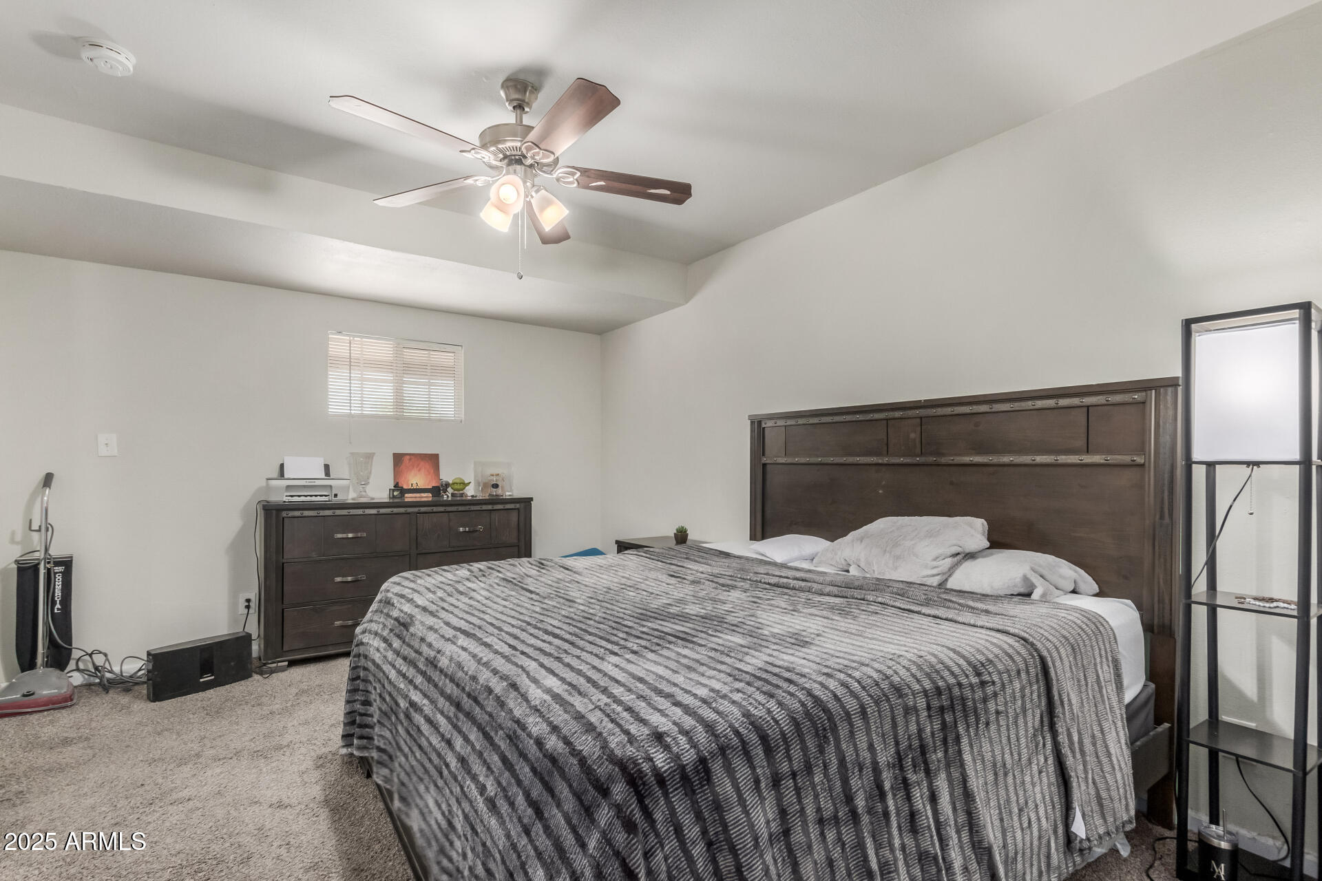 2752 West Royal Palm Road Phoenix, AZ 85051 - Photo 14 of 23 a bedroom with a bed and a chandelier