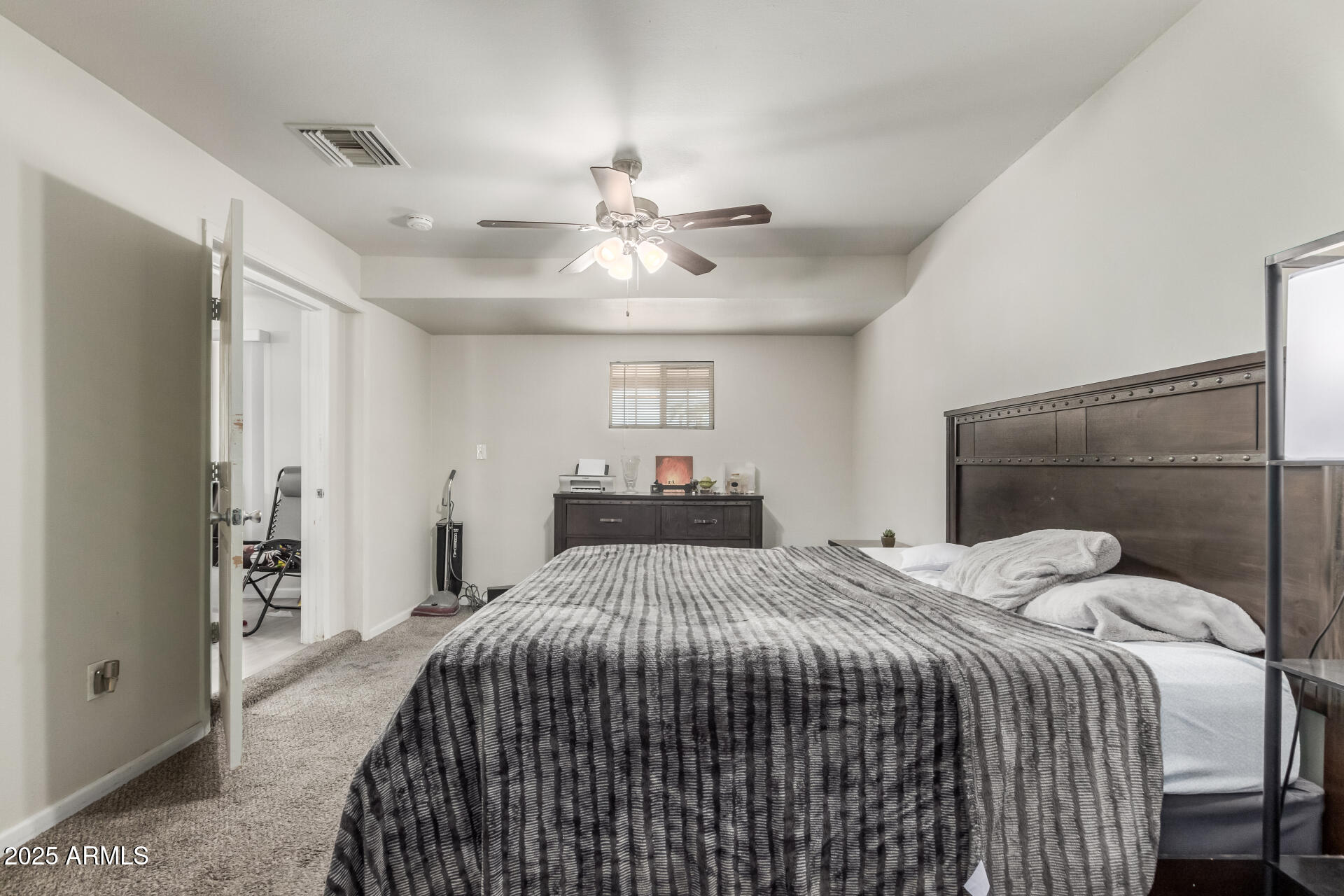 2752 West Royal Palm Road Phoenix, AZ 85051 - Photo 15 of 23 a bedroom with a bed and a chandelier