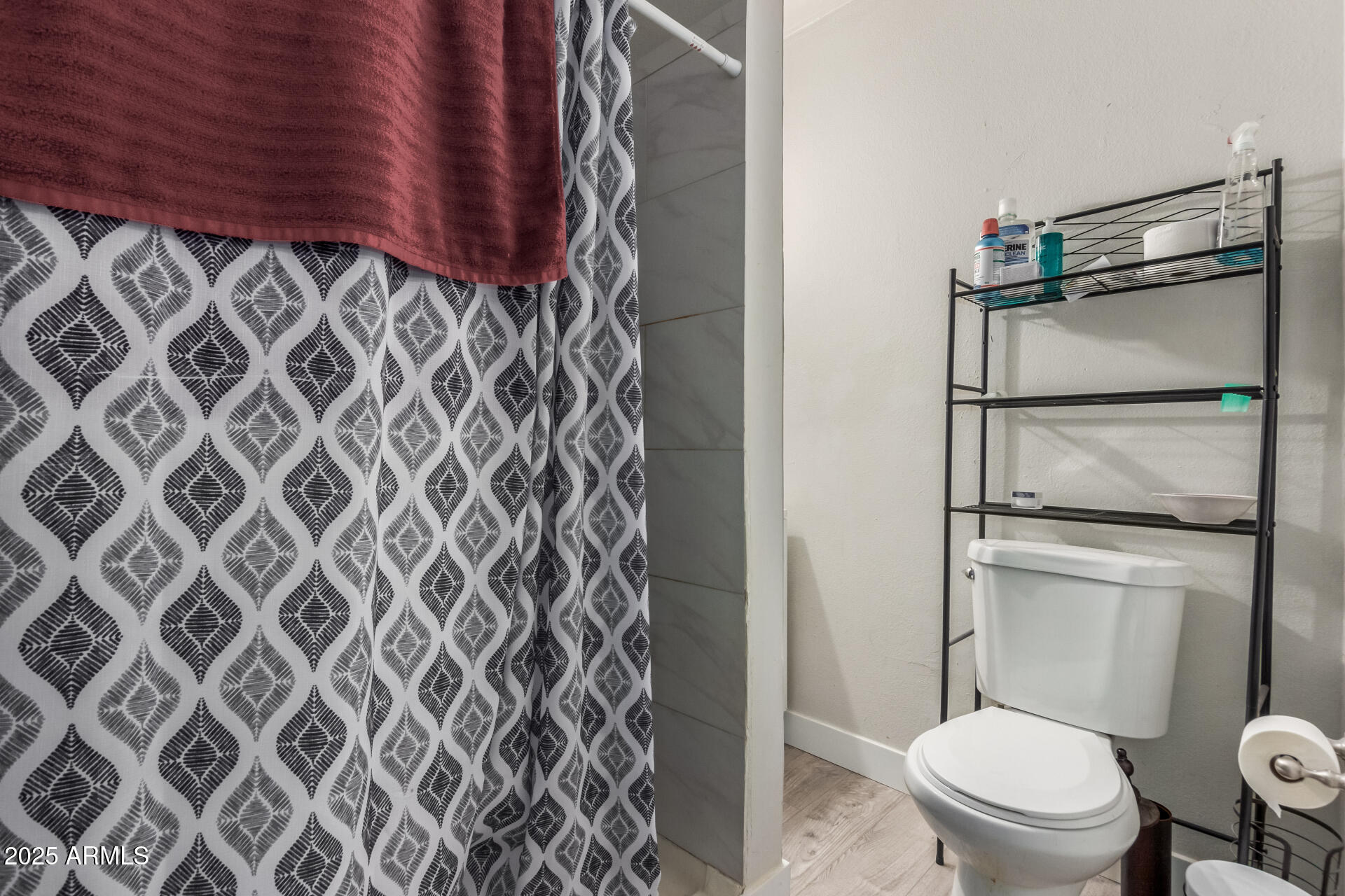 2752 West Royal Palm Road Phoenix, AZ 85051 - Photo 16 of 23 a bathroom with a toilet and a shower