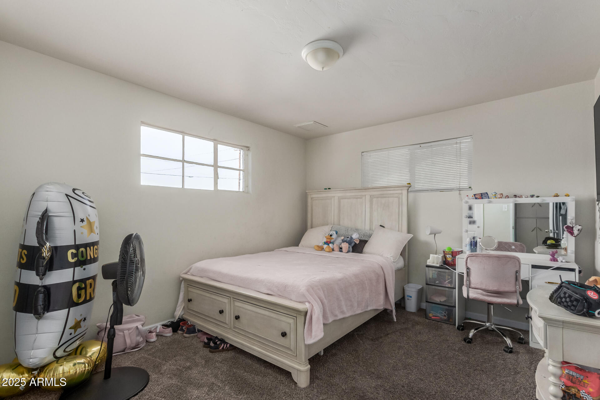 2752 West Royal Palm Road Phoenix, AZ 85051 - Photo 17 of 23 a bedroom with a bed and a window
