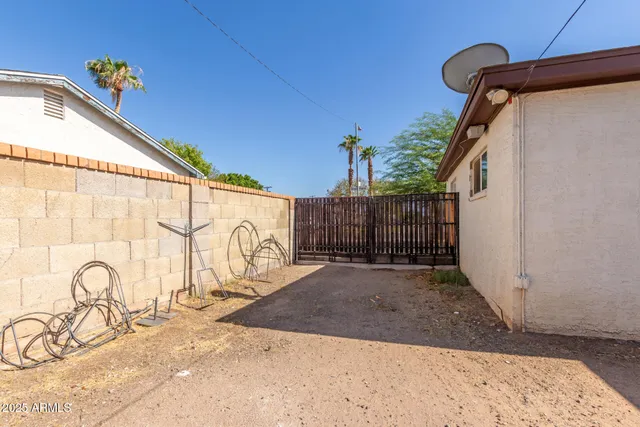 a view of a backyard with a wooden fence