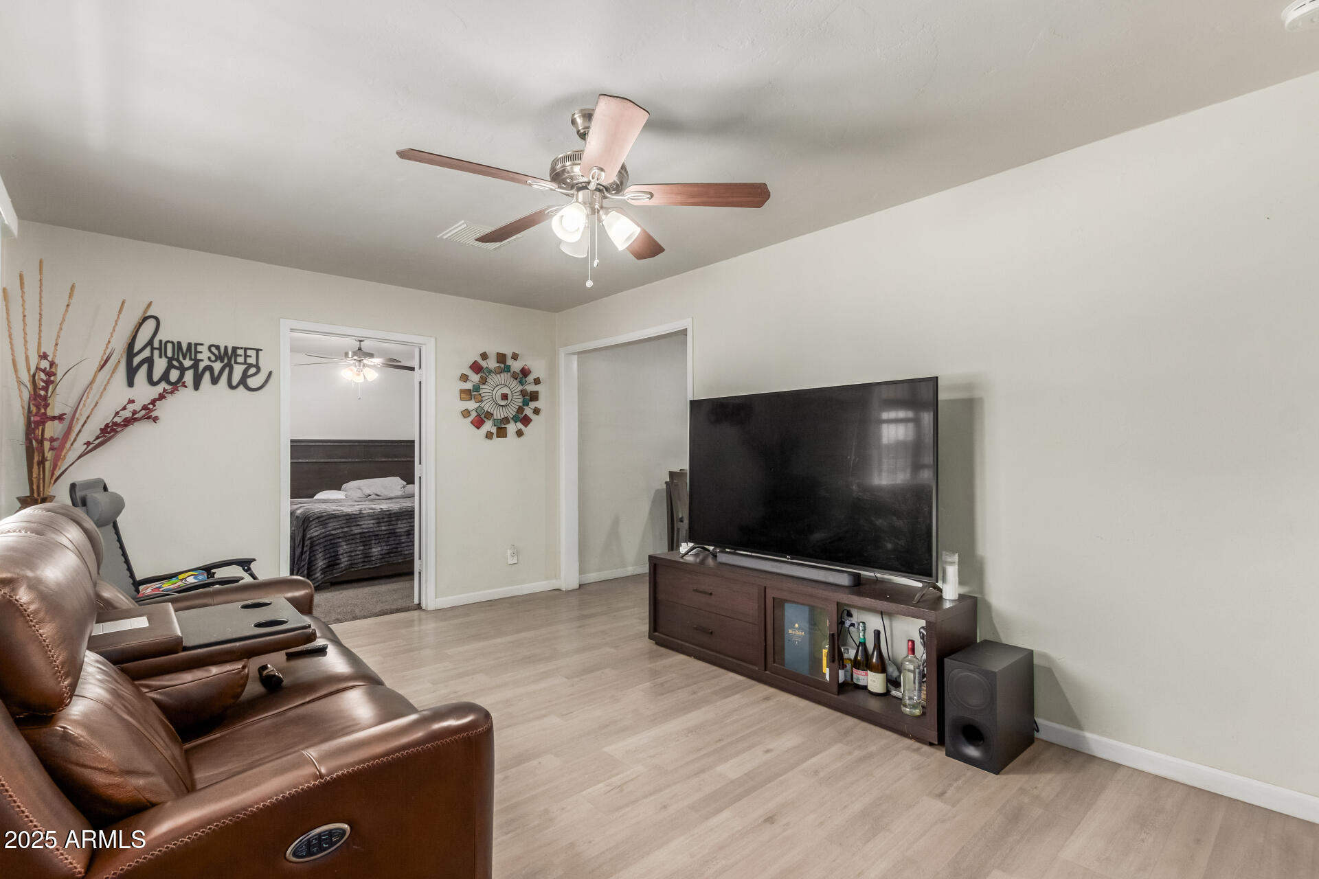 2752 West Royal Palm Road Phoenix, AZ 85051 - Photo 7 of 23 a living room with furniture and a flat screen tv