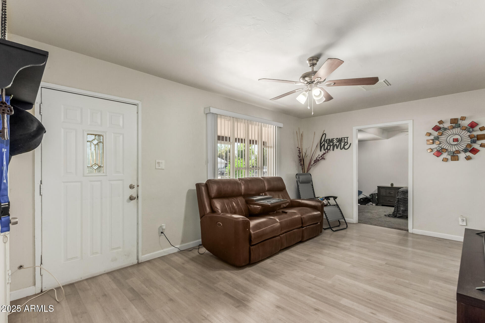 2752 West Royal Palm Road Phoenix, AZ 85051 - Photo 8 of 23 a living room with furniture and a ceiling fan