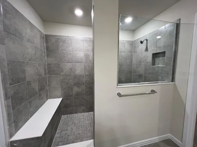 a bathroom with a glass shower door