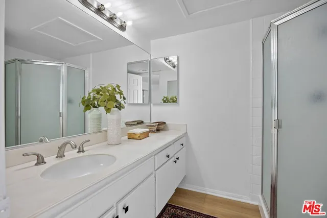 a bathroom with a double vanity sink and a mirror