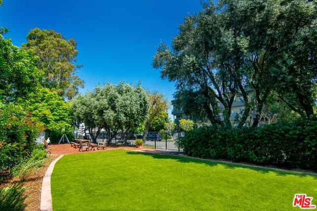a view of yard with swimming pool and green space