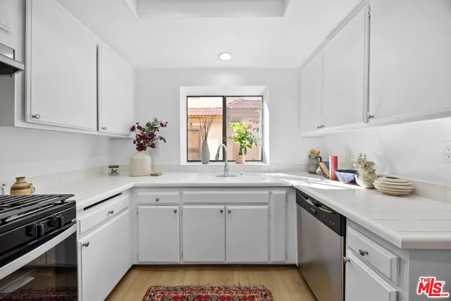 a kitchen with a sink stove and cabinets