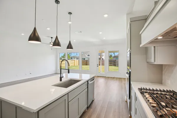 a kitchen with sink cabinets and stove