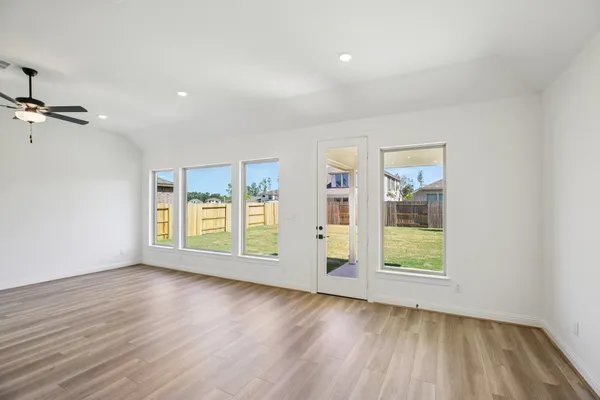wooden floor in an empty room with a window