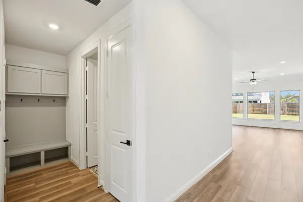 a view of a room with wooden floor and staircase