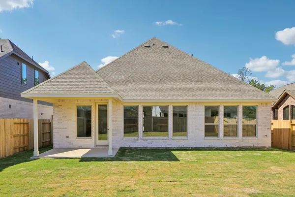 a view of a house with a yard and chandelier