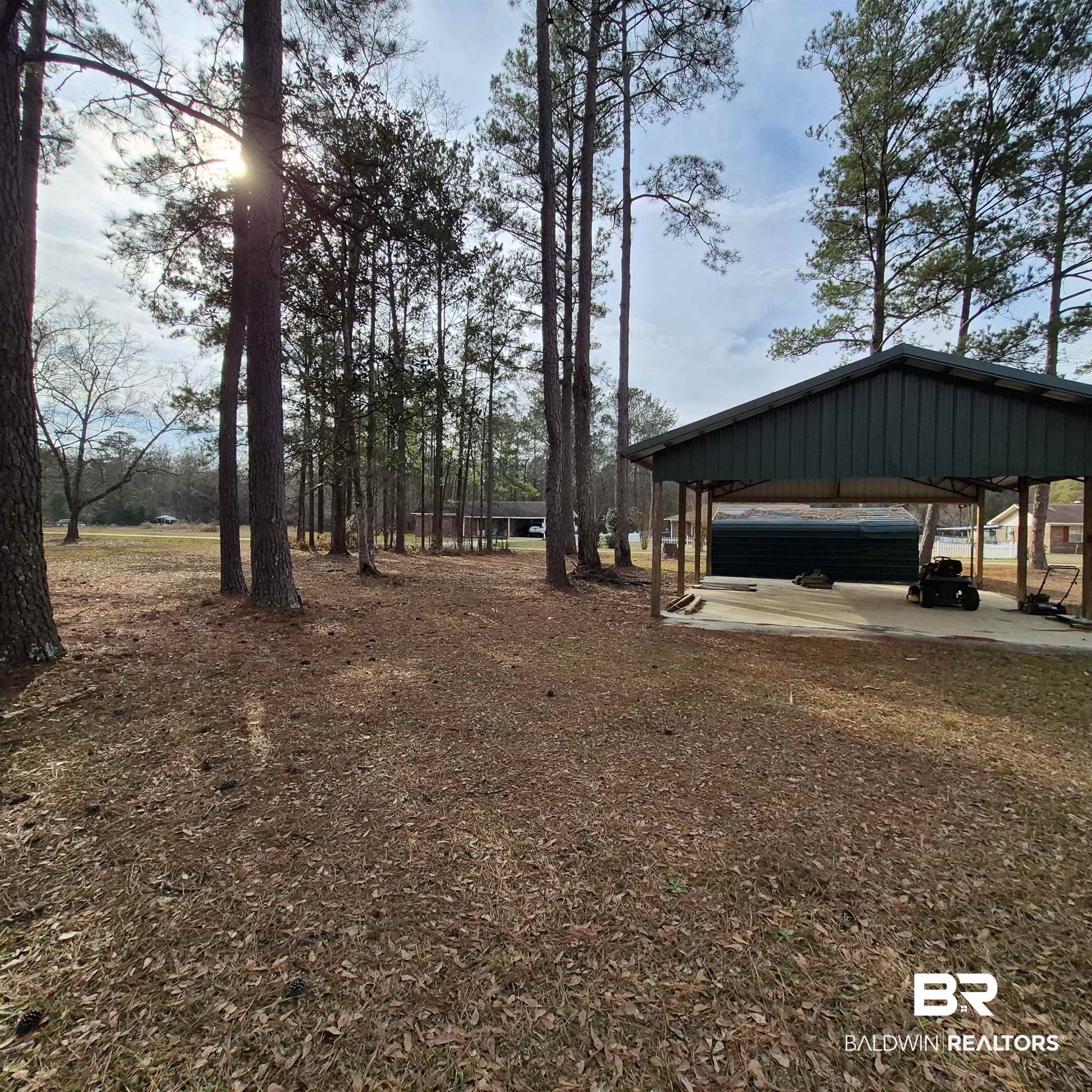491 Forrest Avenue Castleberry, AL 36432 - Photo 29 of 33 View of yard featuring a carport and a patio
