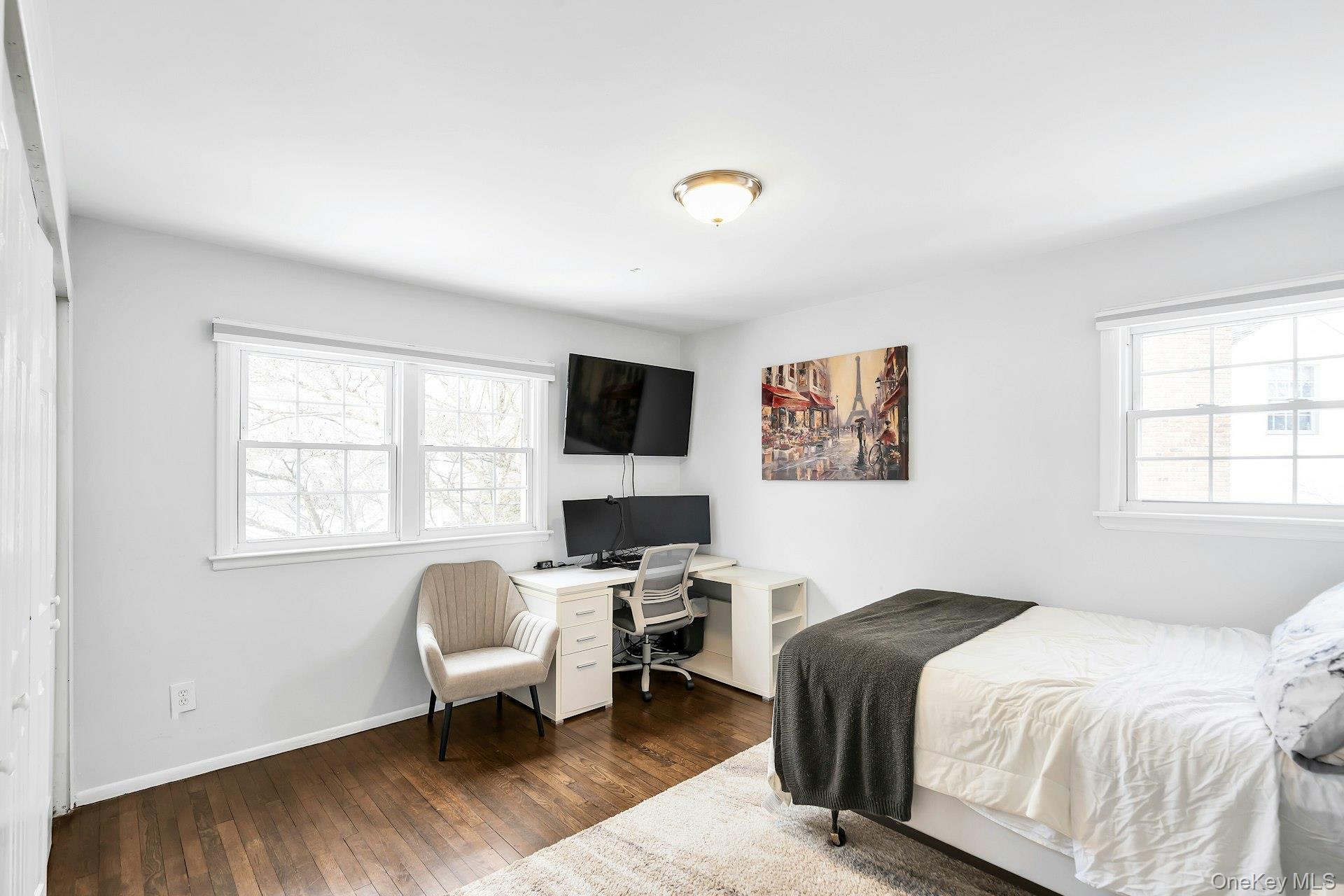 2043 Ripley Lane Merrick, NY 11566 - Photo 33 of 42 a bedroom with a bed and wooden floor