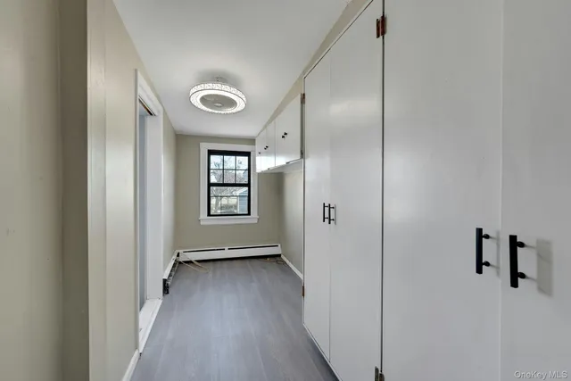 a view of a hallway with wooden floor