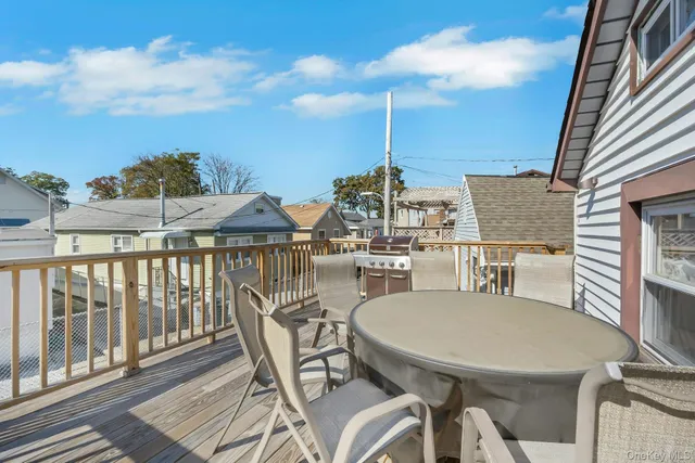 a balcony with table and chairs