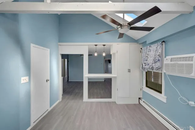 a kitchen with a refrigerator and white cabinets