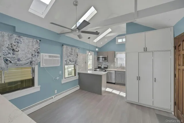 a kitchen with stainless steel appliances granite countertop a refrigerator and a stove top oven