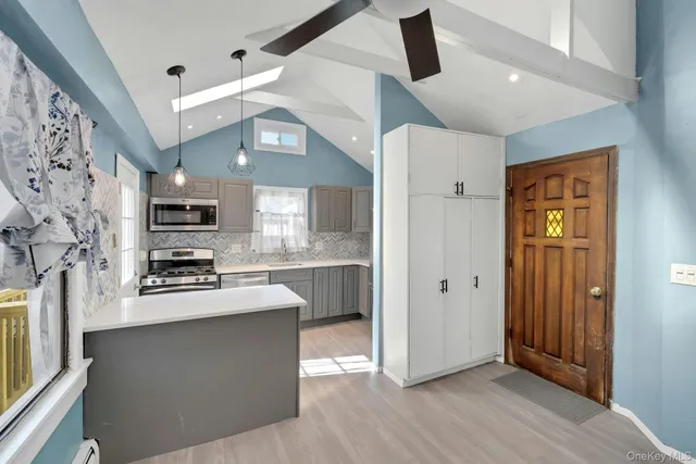 a kitchen with stainless steel appliances a stove a sink dishwasher a refrigerator and a microwave