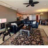 a living room with furniture and a rug