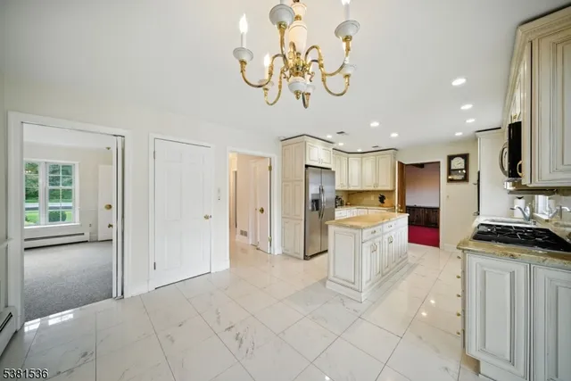 a kitchen with stainless steel appliances granite countertop a refrigerator and a stove top oven