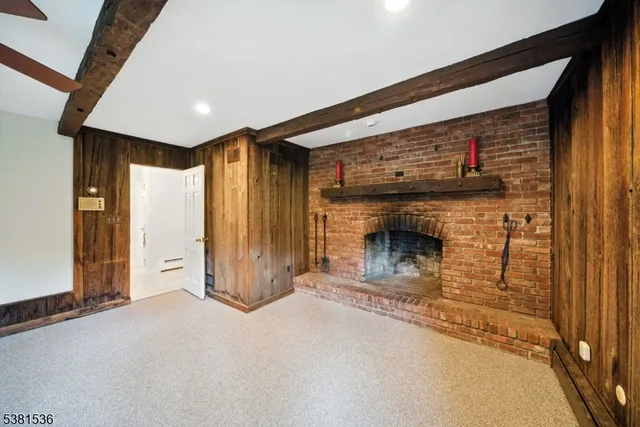 a view of a hallway with wooden floor and a fireplace
