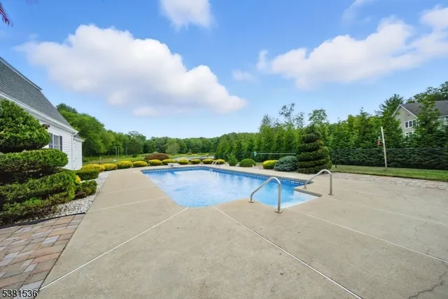 a view of a house with swimming pool and sitting area