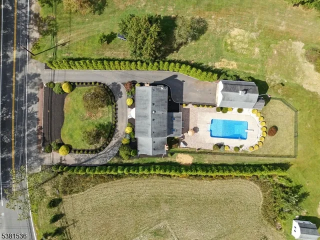 an aerial view of residential house with outdoor space and swimming pool