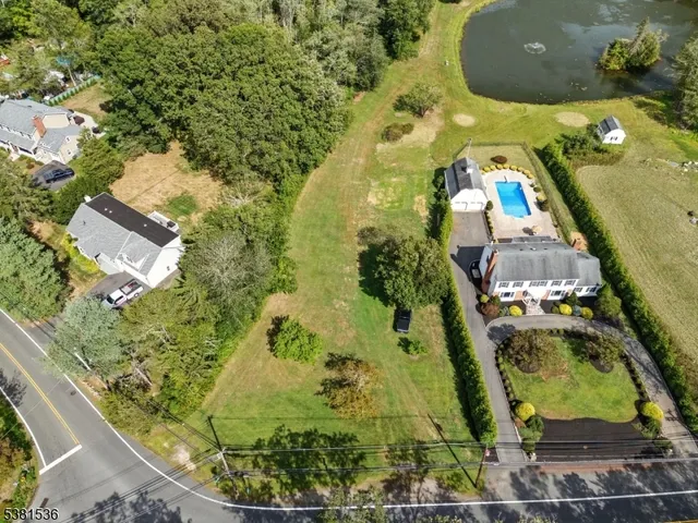 an aerial view of a residential houses with outdoor space
