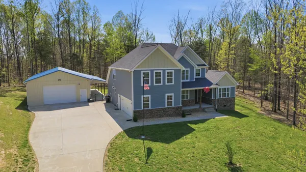 a front view of a house with a yard and pathway
