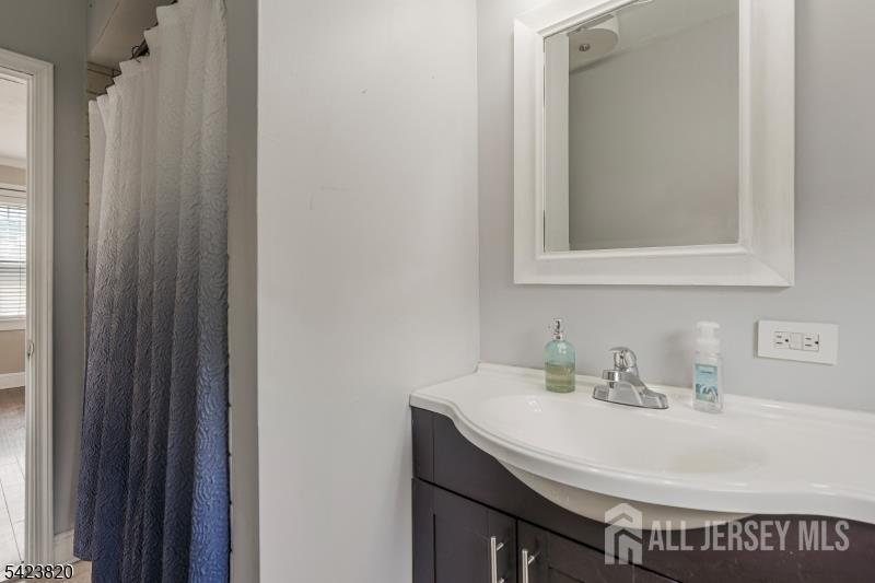 110 Parker Street Middlesex, NJ 08846 - Photo 13 of 25 a bathroom with a sink and a mirror