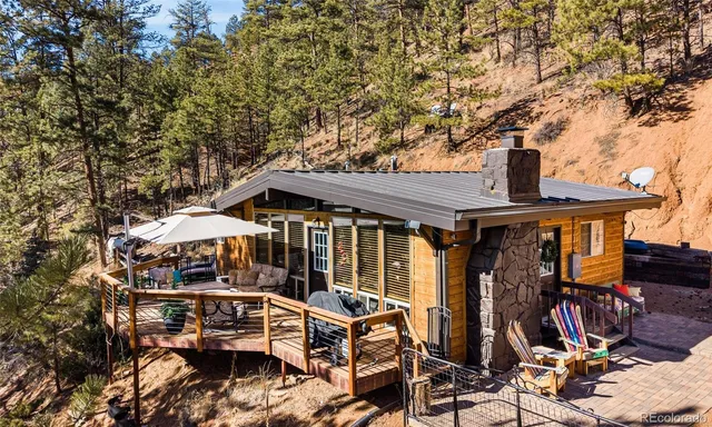 a view of a patio with table and chairs under an umbrella