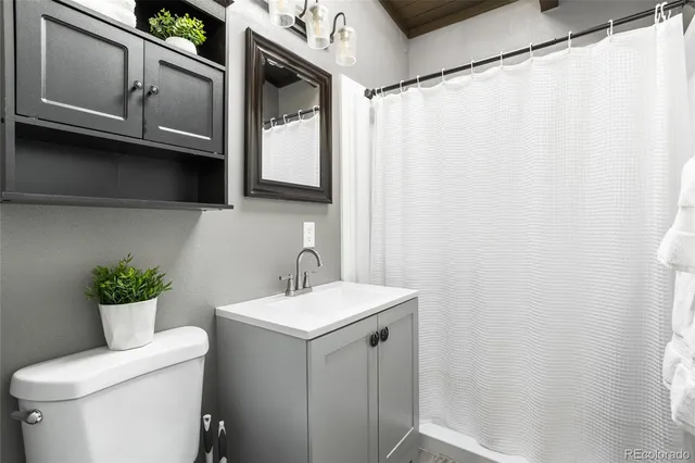 a bathroom with a sink a toilet and mirror