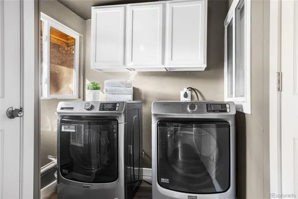 a utility room with sink dryer and washer