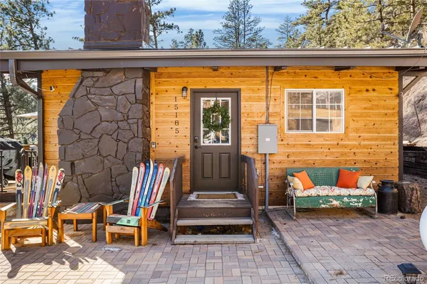 a front view of a house with outdoor seating