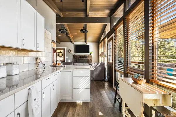 a kitchen with stainless steel appliances a sink window and cabinets