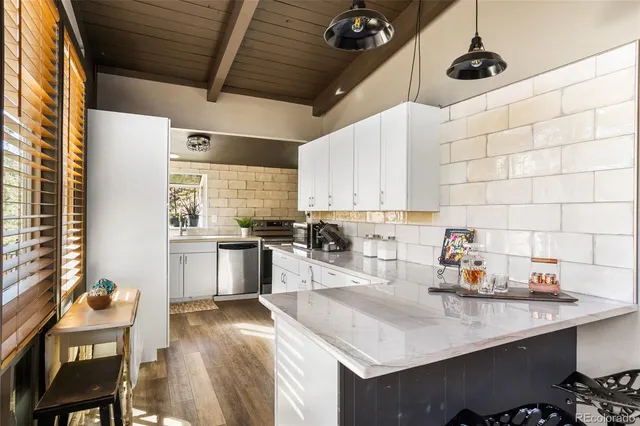 a kitchen with a sink cabinets and window