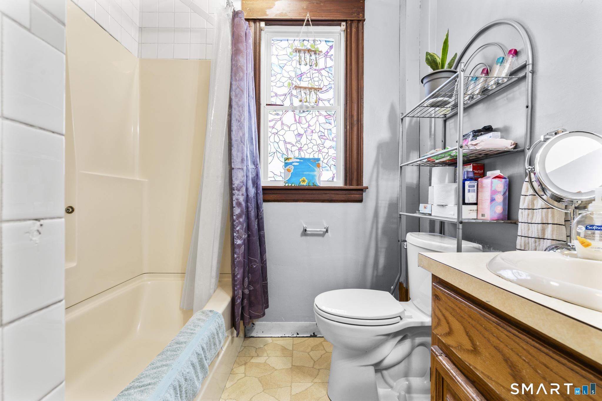 33 Kenney Street Bristol, CT 06010 - Photo 20 of 40 a bathroom with a sink a toilet and a shower curtain