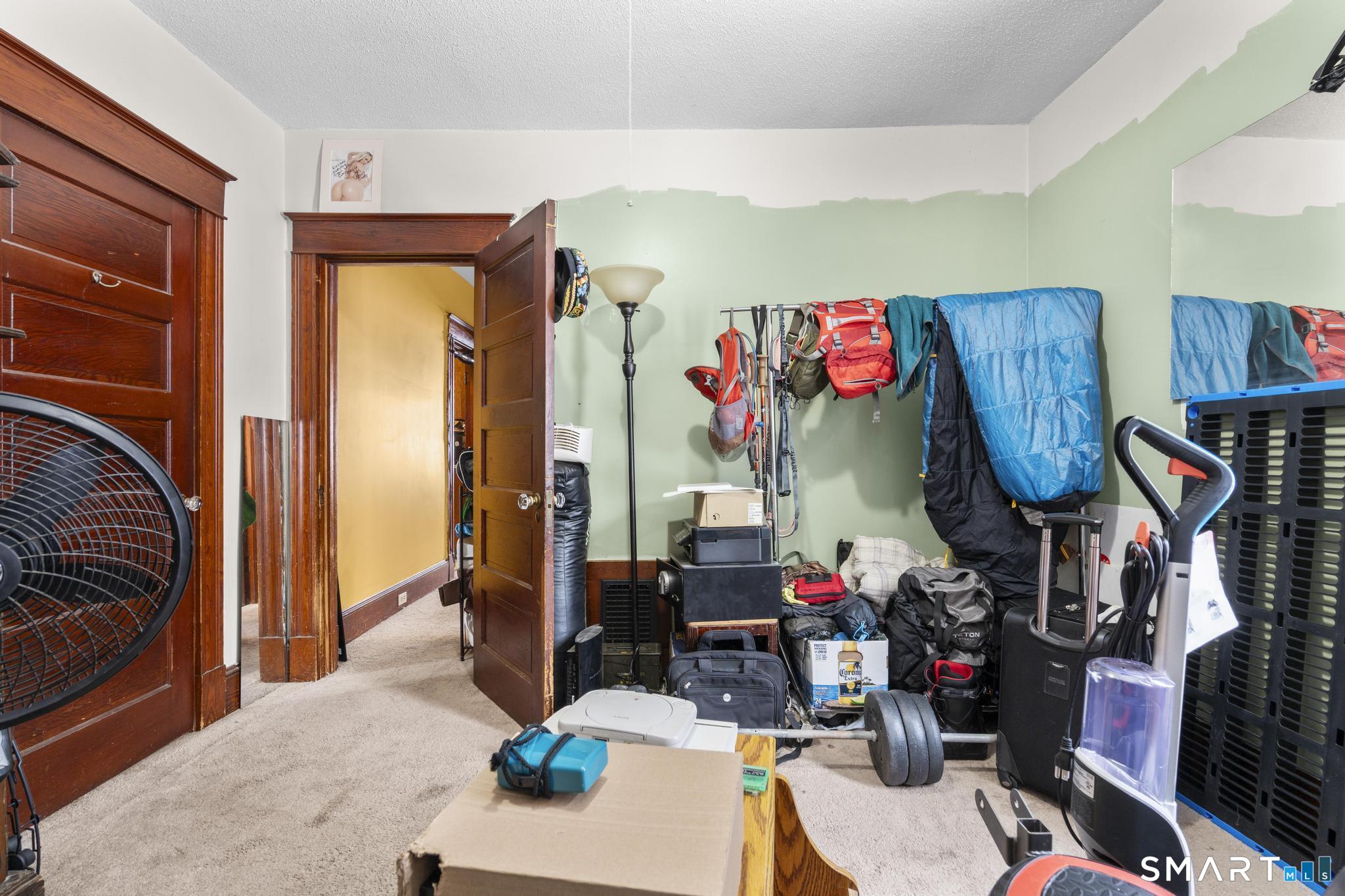 33 Kenney Street Bristol, CT 06010 - Photo 22 of 40 a living room with lots of furniture and clothes
