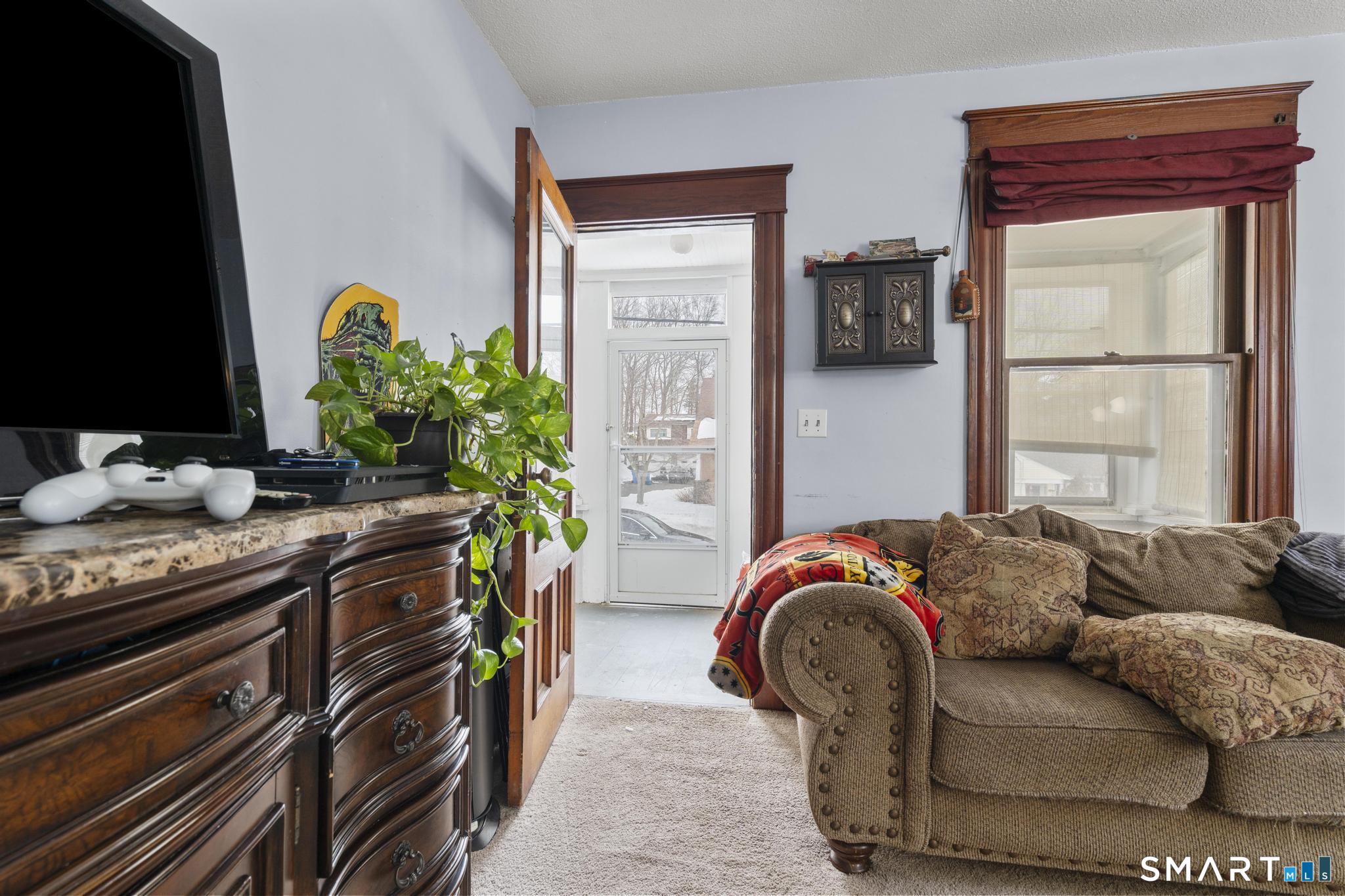 33 Kenney Street Bristol, CT 06010 - Photo 8 of 40 a living room with furniture and a flat screen tv