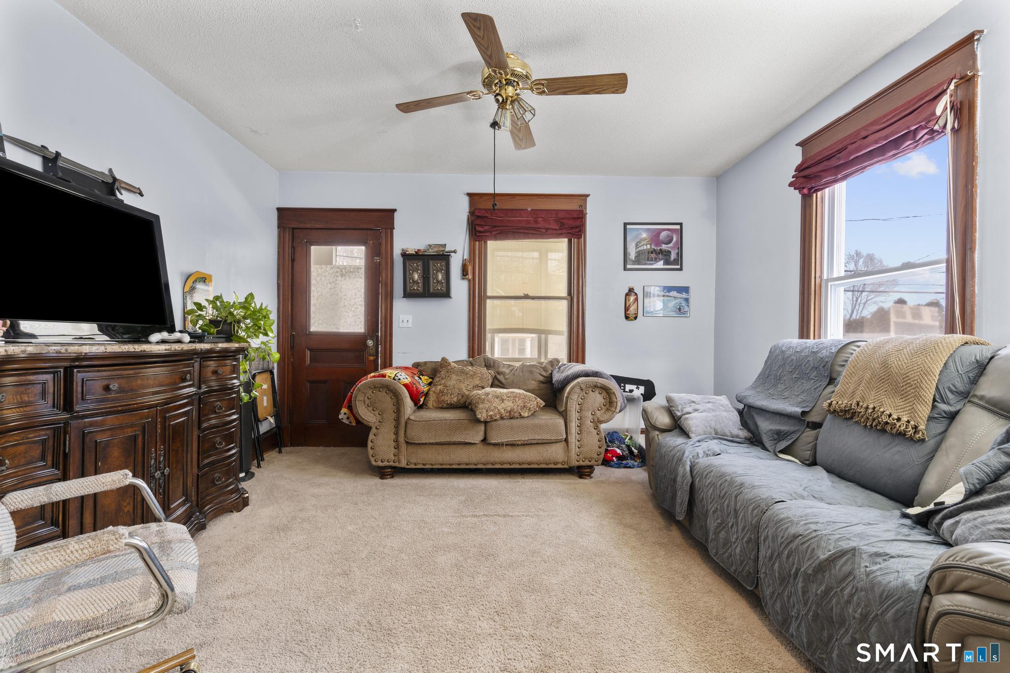 33 Kenney Street Bristol, CT 06010 - Photo 10 of 40 a living room with furniture and a flat screen tv