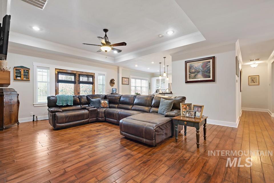 8271 Washoe Road Fruitland, ID 83619 - Photo 13 of 29 Open-concept living space featuring wood-finish flooring, recessed lighting, and a tray ceiling with a ceiling fan