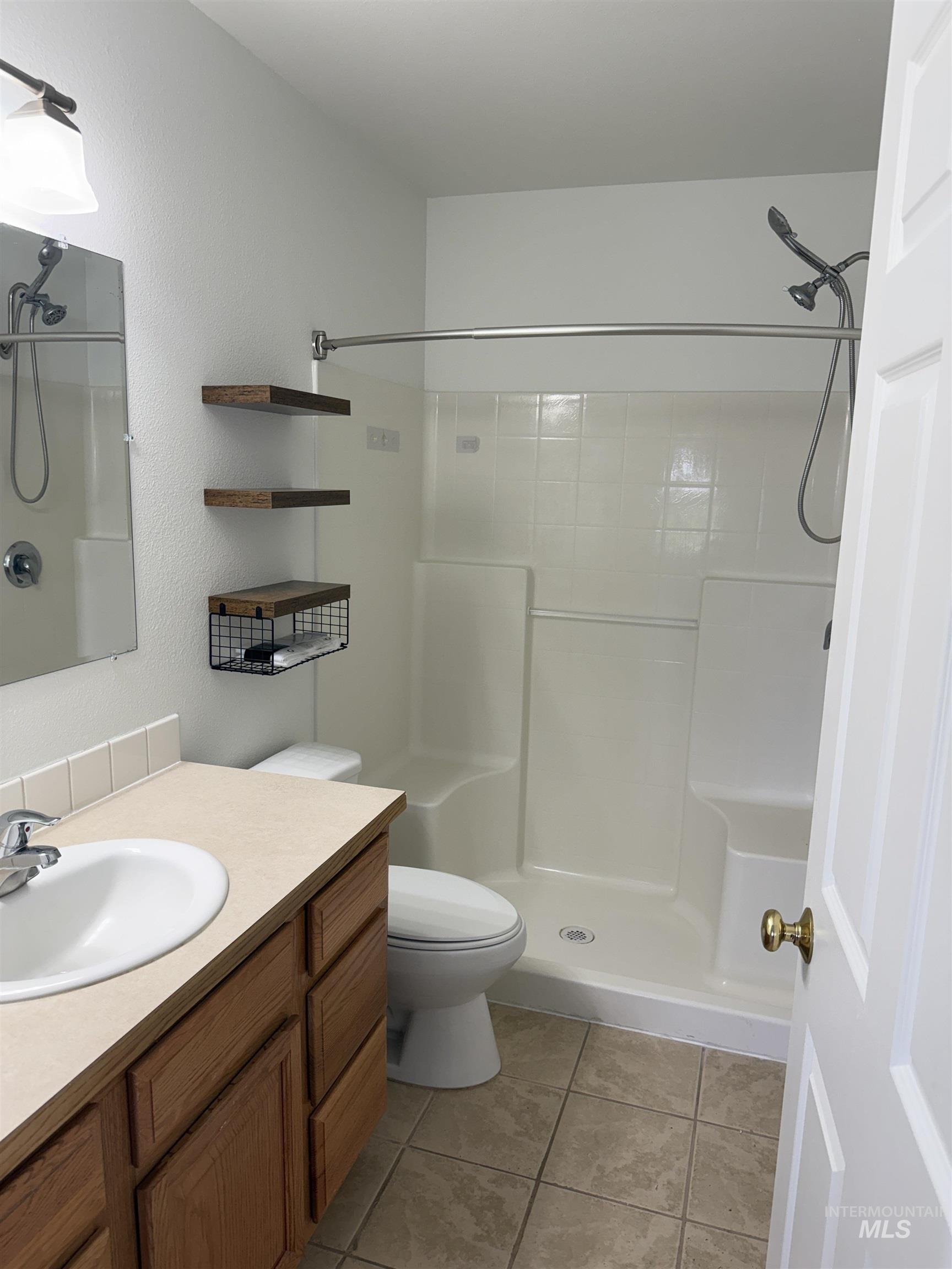 523 Morning Dove Way Marsing, ID 83639 - Photo 20 of 23 Full bathroom featuring vanity, a shower stall, and light tile patterned flooring