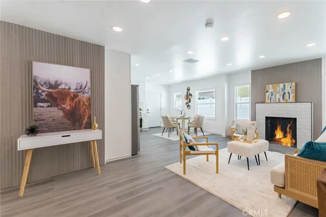 a living room with furniture a fireplace and a wall painting