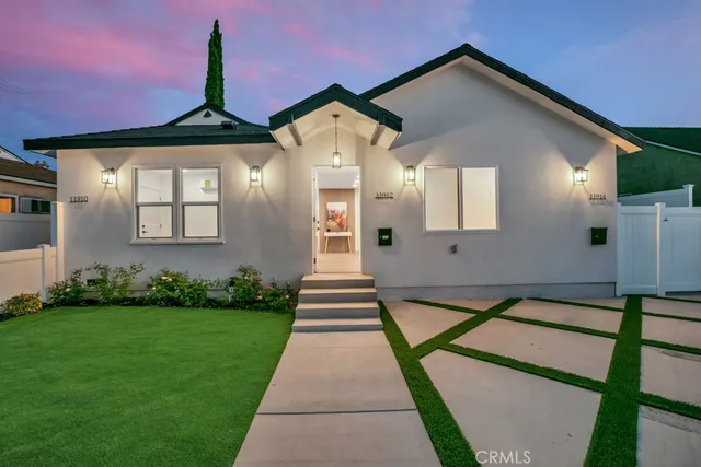 a front view of a house with garden