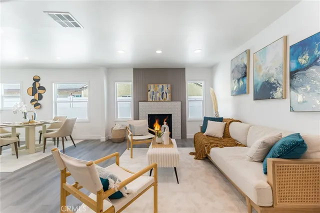 a living room with furniture a fireplace and a table