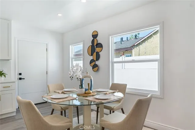 a view of a dining room with furniture and chandelier