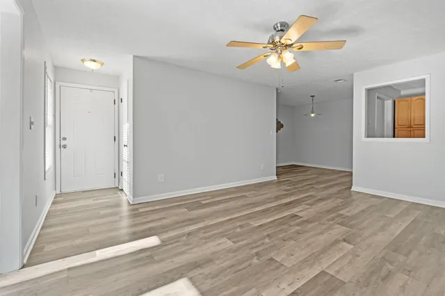wooden floor in an empty room with a window